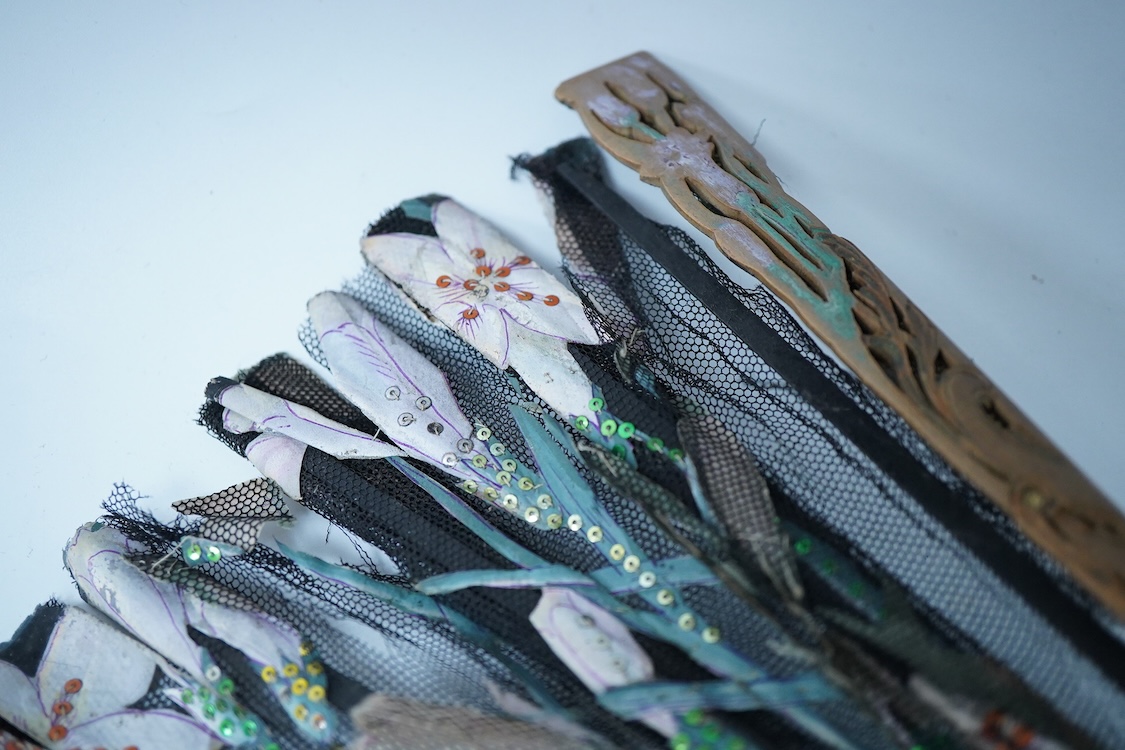 A collection of 19th century and later fans to include a black lacquered and lace example and a hand painted floral example